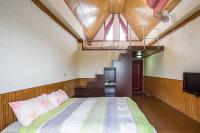 a bedroom with a bed and a staircase with a window at Chenyuan B&amp;B in Ji&#39;an