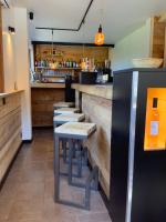 a row of stools at a bar in a restaurant at Hôtel-Bar-Restaurant Les Dômes de Miage in Saint-Gervais-les-Bains