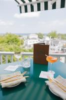 a table with two glasses and a box on it at The Trident Inn in Ogunquit