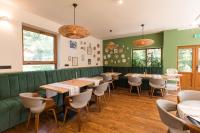 een restaurant met groene muren en tafels en stoelen bij Pensiunea Bucuria Cheia & Ferma Animale in Cheia