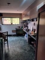 Una cocina con una encimera y una mesa dentro. en Hotel Indra, en Srinagar