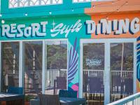 a restaurant with tables and chairs in front of a building at MORIYA iriomote HOTEL in Urauchi