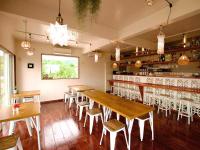a restaurant with wooden tables and chairs and a bar at MORIYA iriomote HOTEL in Urauchi