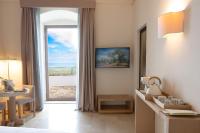 a hotel room with a view of the ocean at La Sommità Relais &amp; Chateaux in Ostuni