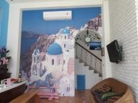 a room with a wall mural of a city at Lighthouse B&amp;B in Dahan