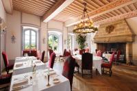a dining room with tables and chairs and a fireplace at Château de Castel Novel Boutique Hôtel in Varetz