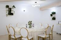 a dining room with a white table and chairs at Complex Turistic Darina Sancraiu de Mures in Sîncraiu de Mureş