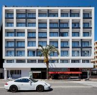 a white car parked in front of a large building at Delamar 4*Sup-Adults only (18+) in Lloret de Mar