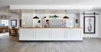 a woman standing at a white counter in a room at Delamar 4*Sup-Adults only (18+) in Lloret de Mar