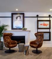 a living room with two chairs and a fireplace at Delamar 4*Sup-Adults only (18+) in Lloret de Mar