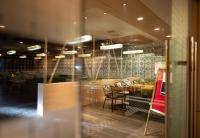 a restaurant with a table and chairs in a room at The Grand Royal Hotel in Samastīpur