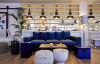 a living room with a blue couch and a table at Delamar 4*Sup-Adults only (18+) in Lloret de Mar