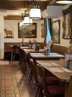 una fila de mesas y sillas en un restaurante en Hotel Zum Lamm, en Garmisch-Partenkirchen