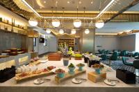 a lobby with a table with bowls of food at Atour X Hotel Shenzhen Bao'an Airport West Bay Mangrove in Bao'an
