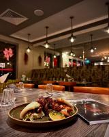 a plate of food on a table in a restaurant at Hudson Berrimah in Darwin