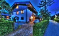 a house with a car parked in front of it at Guesthouse Marko in Bled