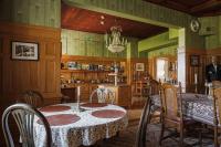 a dining room with a table and chairs at Skogsbrynet B&B, Bredsjö Nya Herrgård in Hällefors