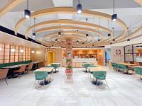 a restaurant with tables and chairs and a large ceiling at Downtown District Hotel in Naga