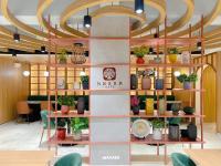 a room with shelves with potted plants on them at Downtown District Hotel in Naga
