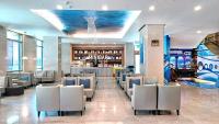 a lobby with chairs and a bar in a building at Hi-YES Hotel Hualien in Hualien City