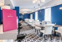 Hotel Sękowski في ليجنيكا: غرفة طعام مع طاولات وكراسي وجدران زرقاء