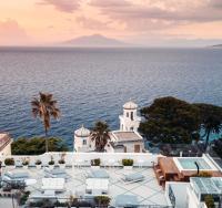 a view of a building and the ocean at Luxury Villa Excelsior Parco in Capri