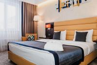 a hotel room with a large bed in a room at Comfort Hotel Astana in Astana