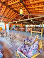 a room with couches and tables in a building at Pousada Pitauá in Socorro
