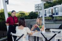 eine Gruppe von drei Frauen, die an einem Tisch sitzen in der Unterkunft The Sterling Villas in Uluwatu