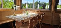 a wooden table with wine glasses and napkins on it at Schwaben Resort Ebnisee in Ebni