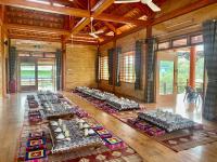 a room with a row of tables in a building at Mely Farm Mường Lò in Văn Chấn