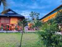 a small tree in front of a building at Mely Farm Mường Lò in Văn Chấn