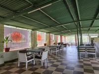 a restaurant with tables and chairs and a checkered floor at Ramma TheHotel - 200 mtrs from Nakki Lake in Mount Ābu
