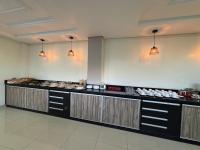 a restaurant kitchen with a buffet of food at Benni Palace Hotel in Parauapebas
