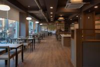 a dining room with tables and chairs and windows at Anook Ryokan Hotel Songtan in Pyeongtaek