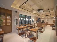 um restaurante com mesas e cadeiras de madeira em uma sala em UH FLAT Signature GANGNAM em Seul