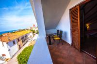 a balcony with a table and a view of the ocean at Apartman Joso in Diklo