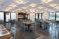 a dining room with tables and chairs and windows at Montelleri Residenza di Campagna in Vicchio