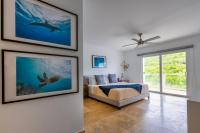 a bedroom with a bed and pictures on the wall at Anchors Hotel in Fajardo