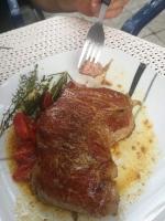 a piece of meat on a plate with a fork at Gasthaus Schmidt's in Neuhaldensleben
