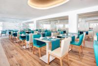 a restaurant with blue and white tables and chairs at The Sea Hotel by Grupotel - Adults Only in Can Picafort