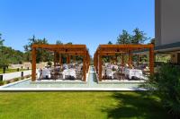 a restaurant with tables and chairs on a patio at Cabú Hotel - Adults Only in Faliraki