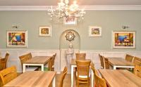 a dining room with wooden tables and a statue at Rooms near Weston-super-Mare in Uphill