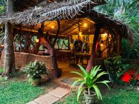 a man sitting at a table in a restaurant at Aloe Vera Guest House in Dambulla