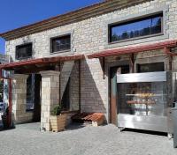 a store front of a brick building at Omalia Village in Áno Khóra