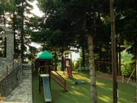 a park with a playground with a slide at Omalia Village in Áno Khóra