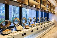 a buffet line with bowls and plates of food at 北京明珠酒店Beijing CSN Pearl Hotel in Beijing