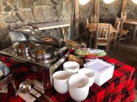 a table with a stove and plates of food at Isalaasha Bush Camp in Mau Narok