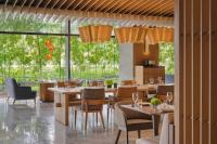 クアラルンプールにあるHyatt Regency Kuala Lumpur at KL Midtownのテーブルと椅子と大きな窓のあるレストラン