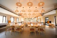 a dining room with tables and chairs and chandeliers at Vinaika Eco-Resort in Rānchī